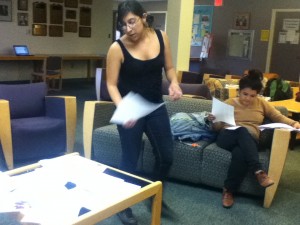 Staff member Rosario, and Digital Editor Sara, looking over some of the many student works that are slotted to be published this year.