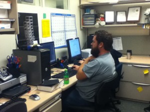 Staff member James working on Indesign during the Production Workshop.